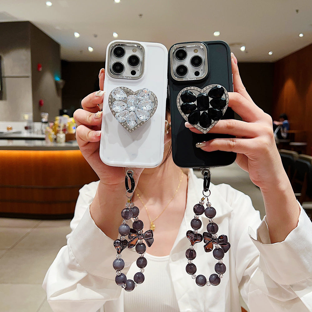 Stone Heart Shape Stand Silicone Soft Phone Case with Bracelet - iPhone 15 Plus